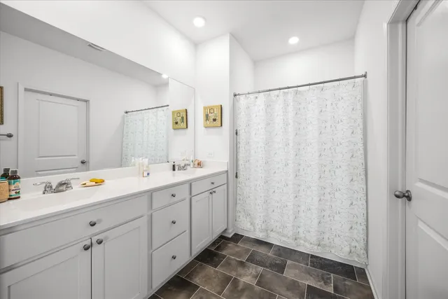 a bathroom with a double vanity sink and mirror