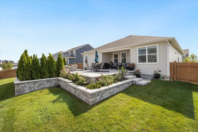 a view of a house with swimming pool and a yard