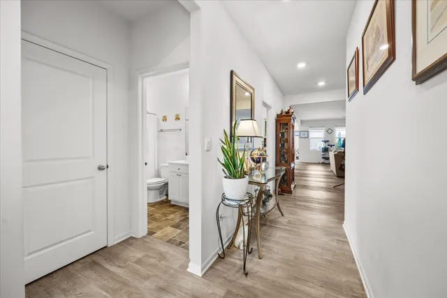a view of an entryway with wooden floor and a livingroom view