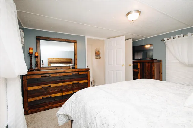 a bedroom with a bed and a bathroom