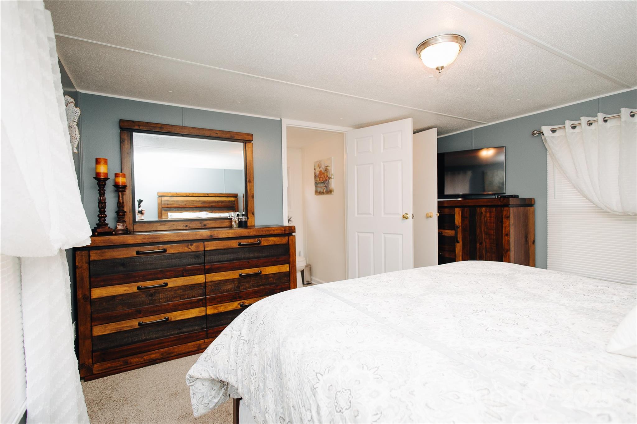 325 Griggs Road Old Fort, NC 28762 - Photo 15 of 36 a bedroom with a bed and a flat screen tv