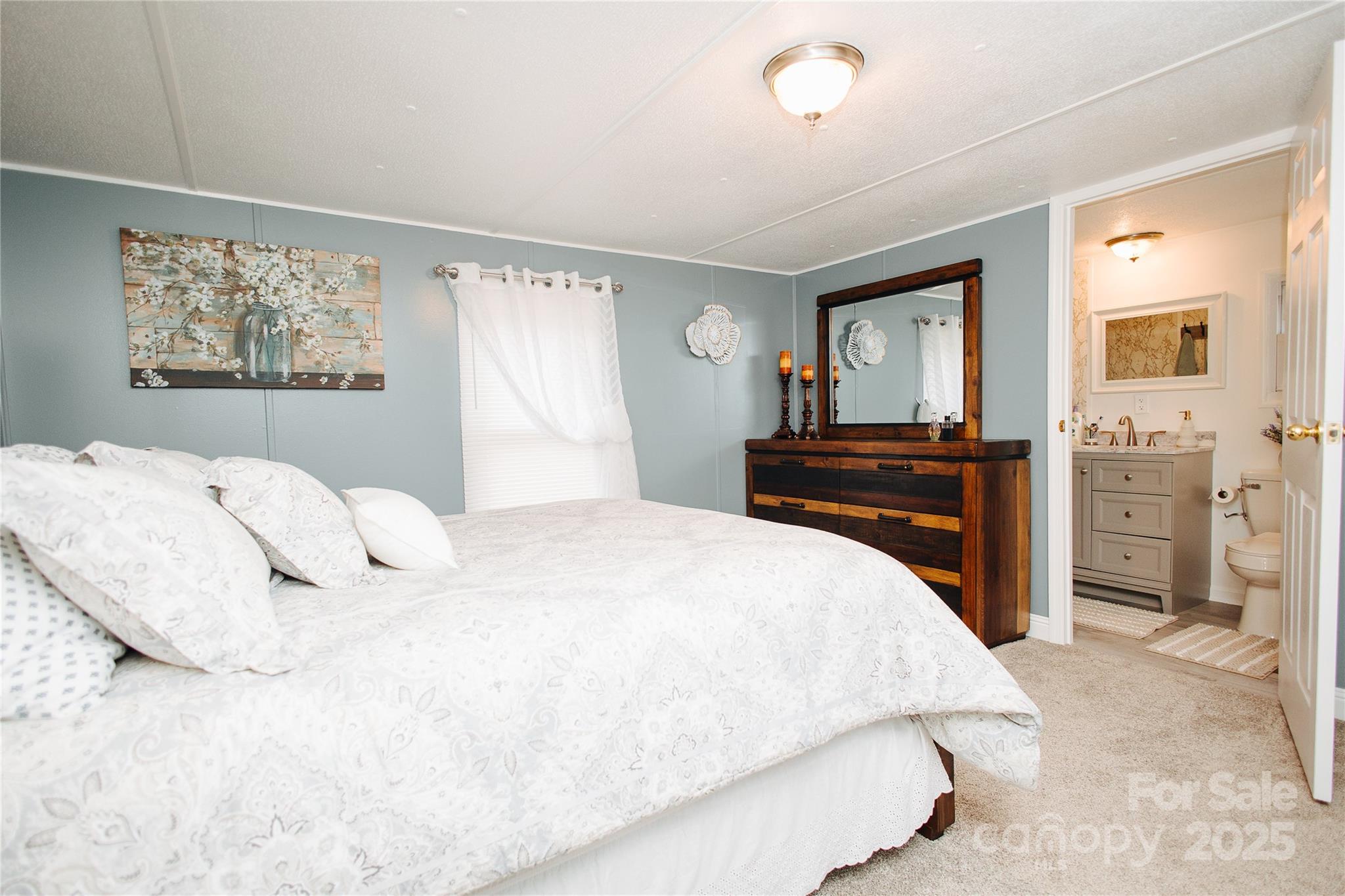 325 Griggs Road Old Fort, NC 28762 - Photo 18 of 36 a bedroom with a bed and a dresser