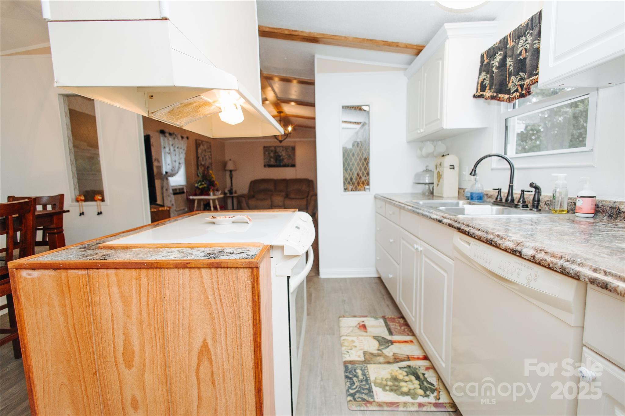 325 Griggs Road Old Fort, NC 28762 - Photo 22 of 36 a dining hall with stainless steel appliances granite countertop a sink and dishwasher