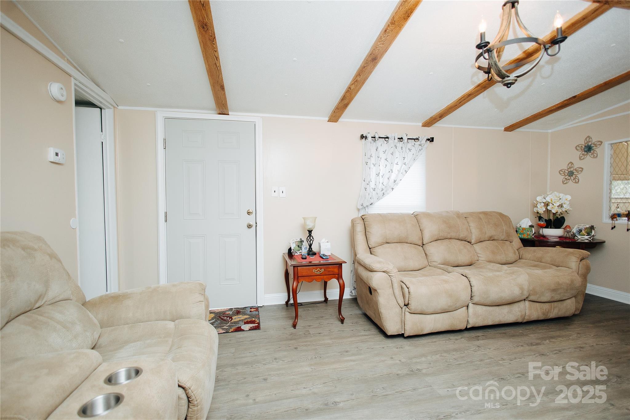 325 Griggs Road Old Fort, NC 28762 - Photo 31 of 36 a living room with furniture and a chandelier