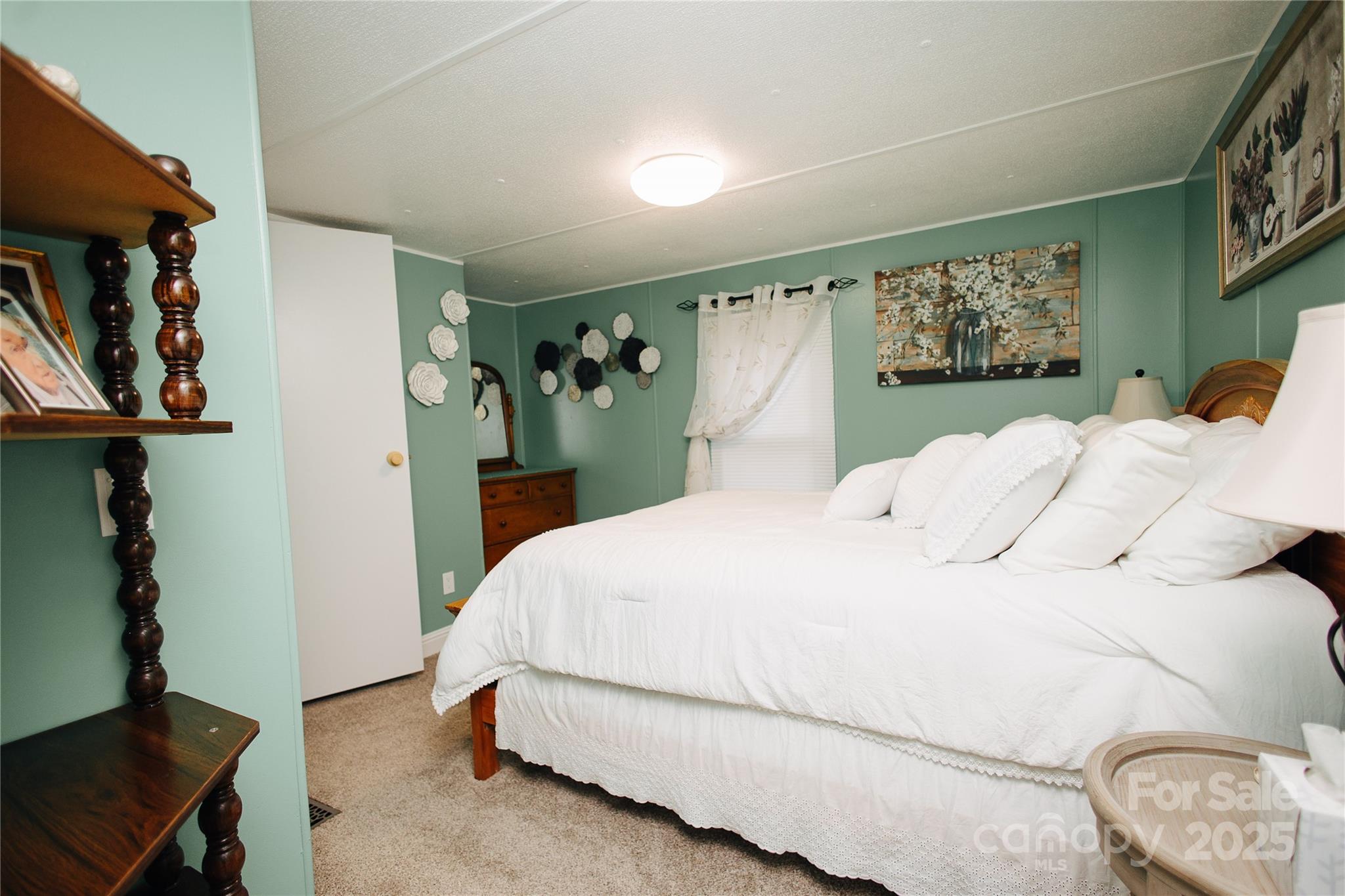 325 Griggs Road Old Fort, NC 28762 - Photo 33 of 36 a bedroom with a large bed and a window