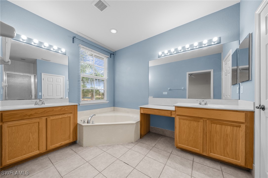 3844 Cherrybrook Loop Fort Myers, FL 33966 - Photo 14 of 29 a bathroom with a tub sink and mirror