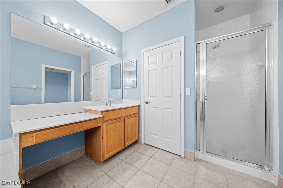 3844 Cherrybrook Loop Fort Myers, FL 33966 - Photo 15 of 29 a spacious bathroom with a mirror and a shower