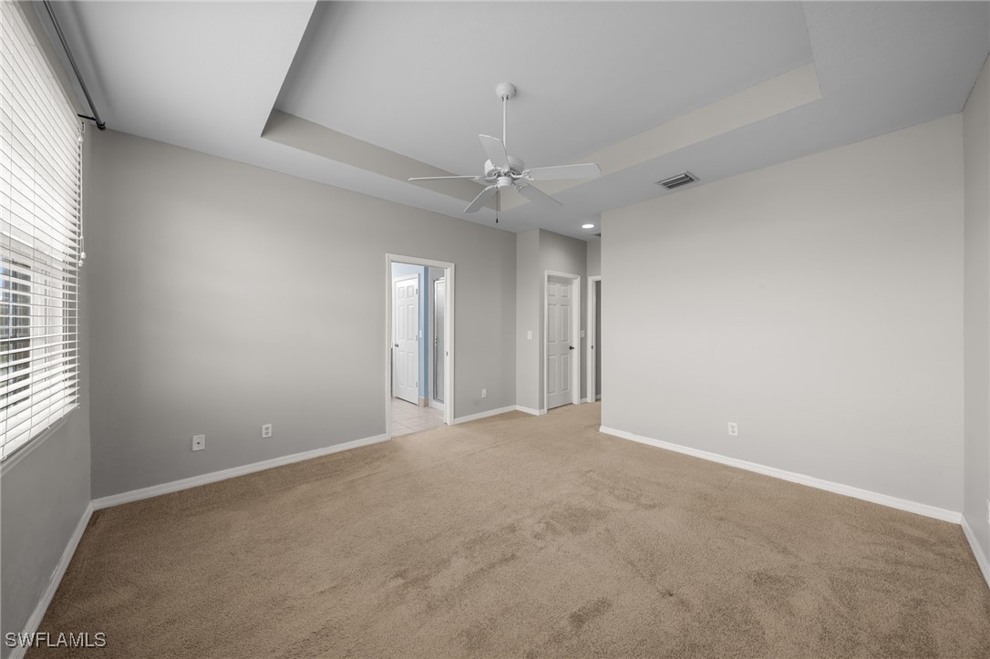 3844 Cherrybrook Loop Fort Myers, FL 33966 - Photo 19 of 29 en empty room with windows and chandelier fan