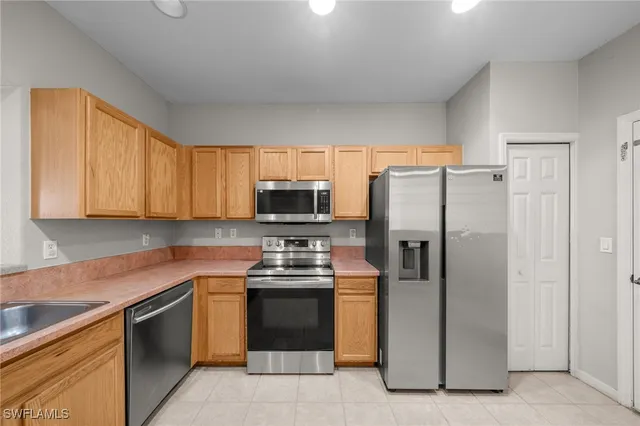 a kitchen with stainless steel appliances granite countertop a refrigerator stove a sink and dishwasher