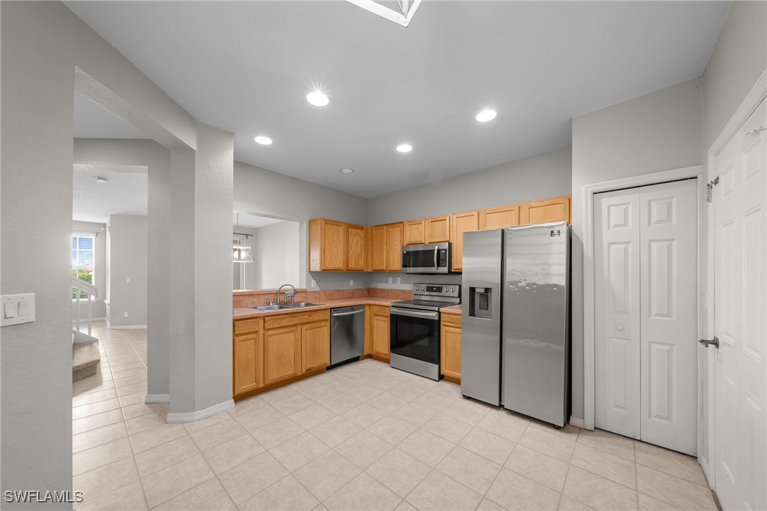 3844 Cherrybrook Loop Fort Myers, FL 33966 - Photo 6 of 29 a kitchen with stainless steel appliances granite countertop a refrigerator and a stove top oven