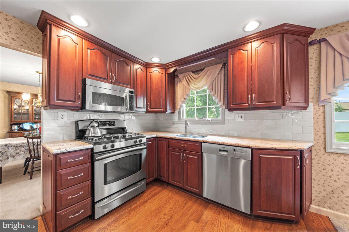 5 Everington Road Marlton, NJ 08053 - Photo 15 of 45 a kitchen with stainless steel appliances granite countertop a stove a sink dishwasher and a microwave oven with cabinets