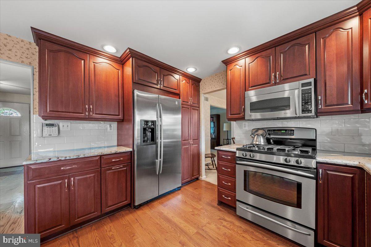 5 Everington Road Marlton, NJ 08053 - Photo 16 of 45 a kitchen with granite countertop wooden cabinets stainless steel appliances and a window