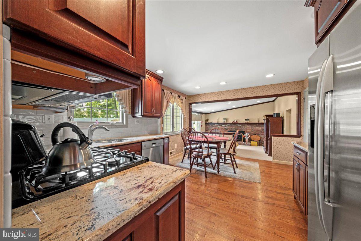 5 Everington Road Marlton, NJ 08053 - Photo 17 of 45 a kitchen with stainless steel appliances granite countertop a sink a stove and a refrigerator