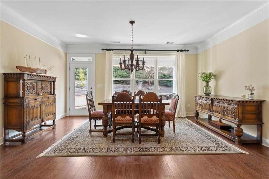 3457 Locust Cove Road Gainesville, GA 30504 - Photo 17 of 54 a dining room with furniture a rug and a chandelier