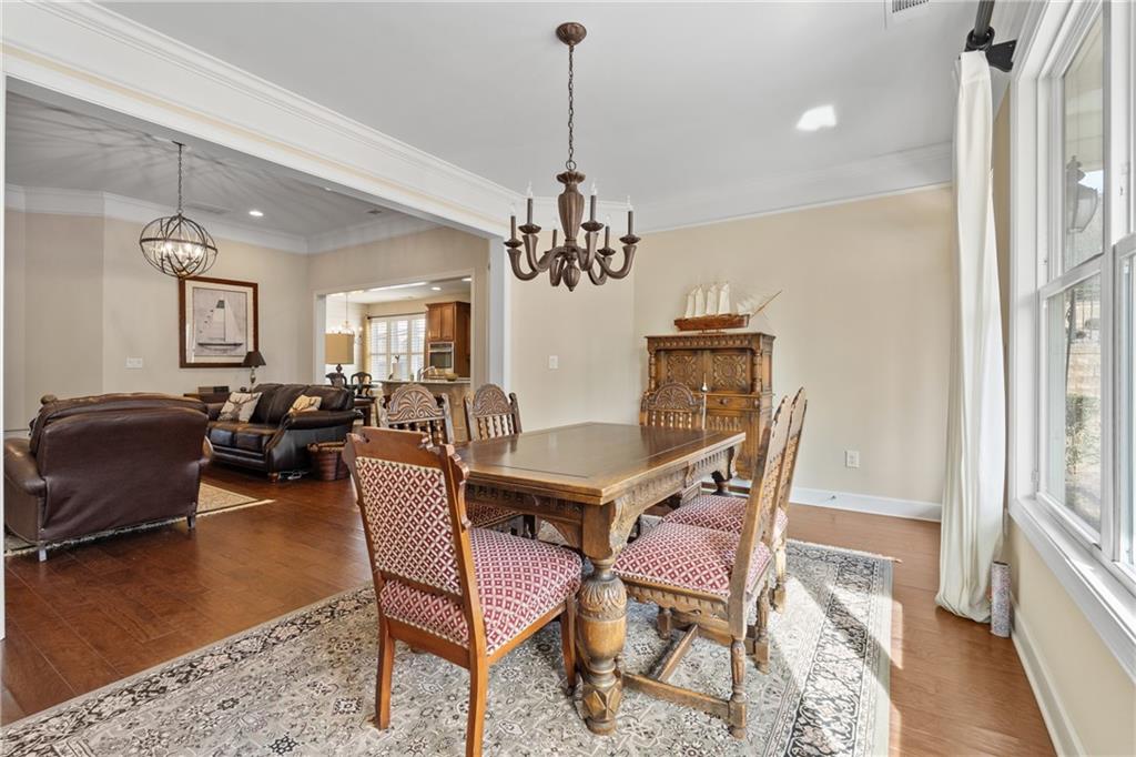 3457 Locust Cove Road Gainesville, GA 30504 - Photo 19 of 54 a dining room with furniture a chandelier and wooden floor