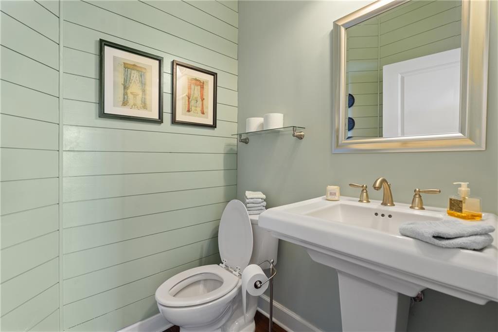 3457 Locust Cove Road Gainesville, GA 30504 - Photo 23 of 54 a bathroom with a toilet a sink and mirror