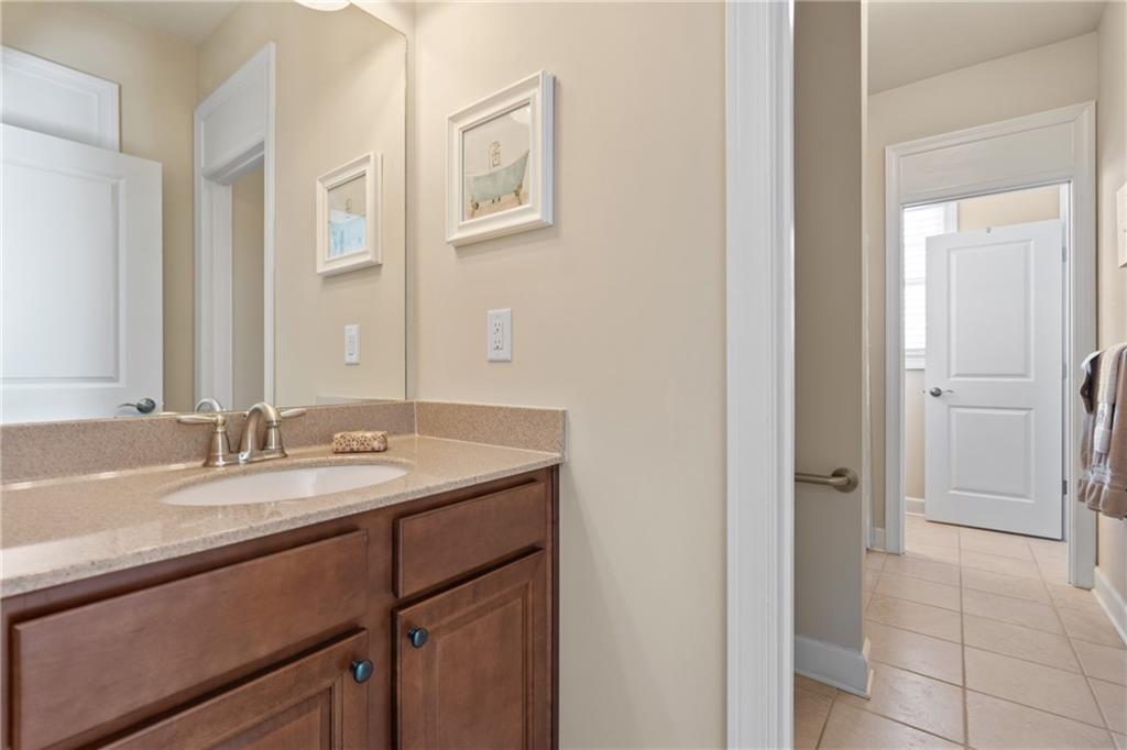 3457 Locust Cove Road Gainesville, GA 30504 - Photo 28 of 54 a bathroom with a granite countertop sink and a mirror