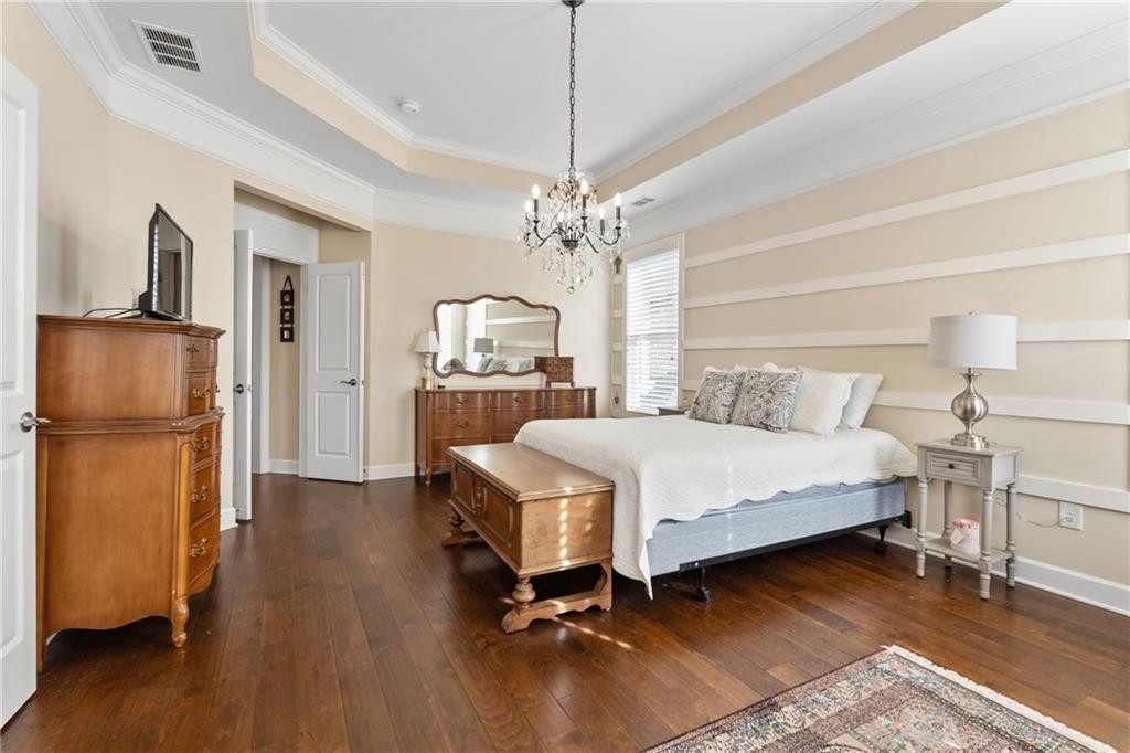 3457 Locust Cove Road Gainesville, GA 30504 - Photo 32 of 54 a bed room with a bed and a chandelier