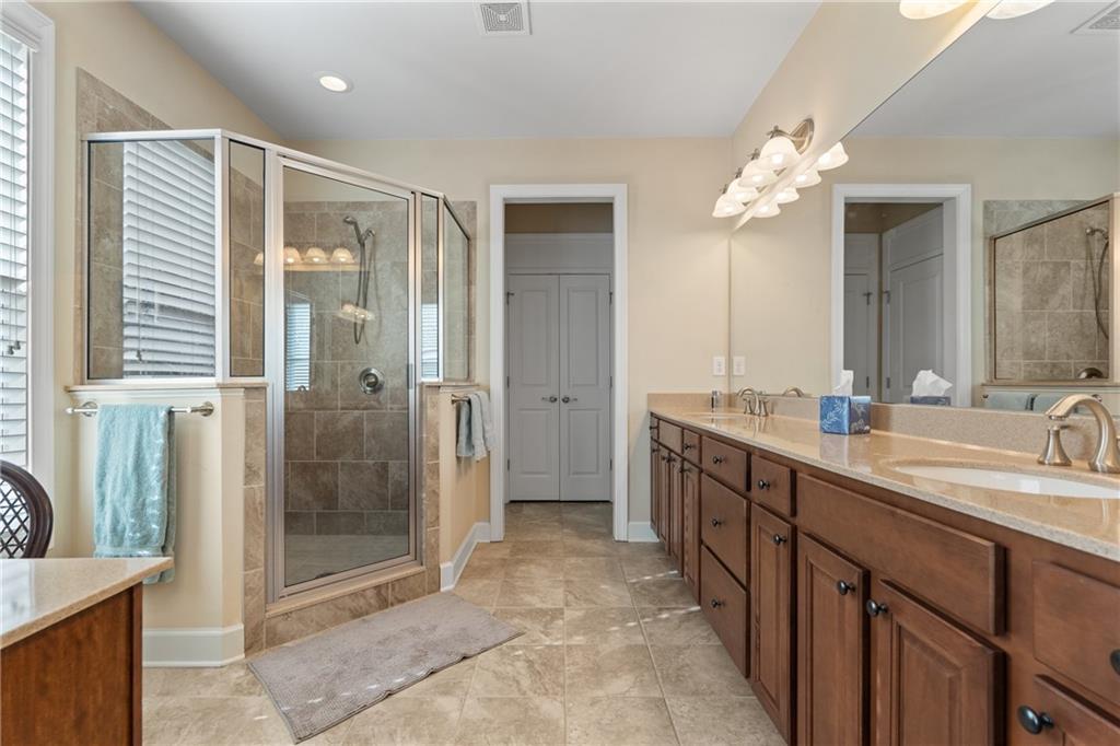 3457 Locust Cove Road Gainesville, GA 30504 - Photo 34 of 54 a spacious bathroom with a shower sink and mirror