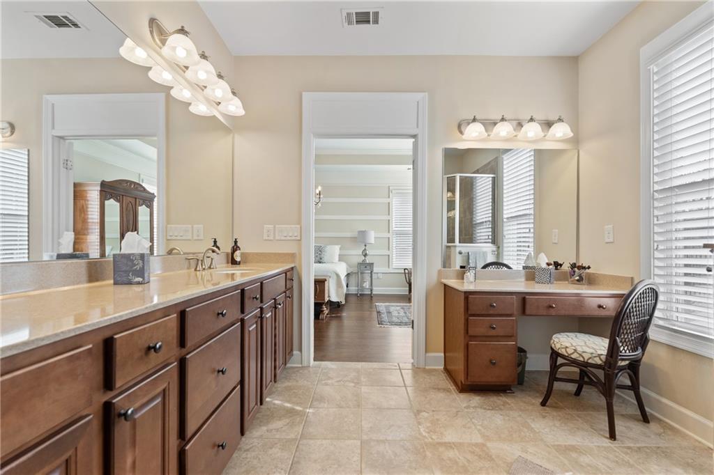 3457 Locust Cove Road Gainesville, GA 30504 - Photo 35 of 54 a spacious bathroom with a granite countertop sink a large mirror and a bathtub