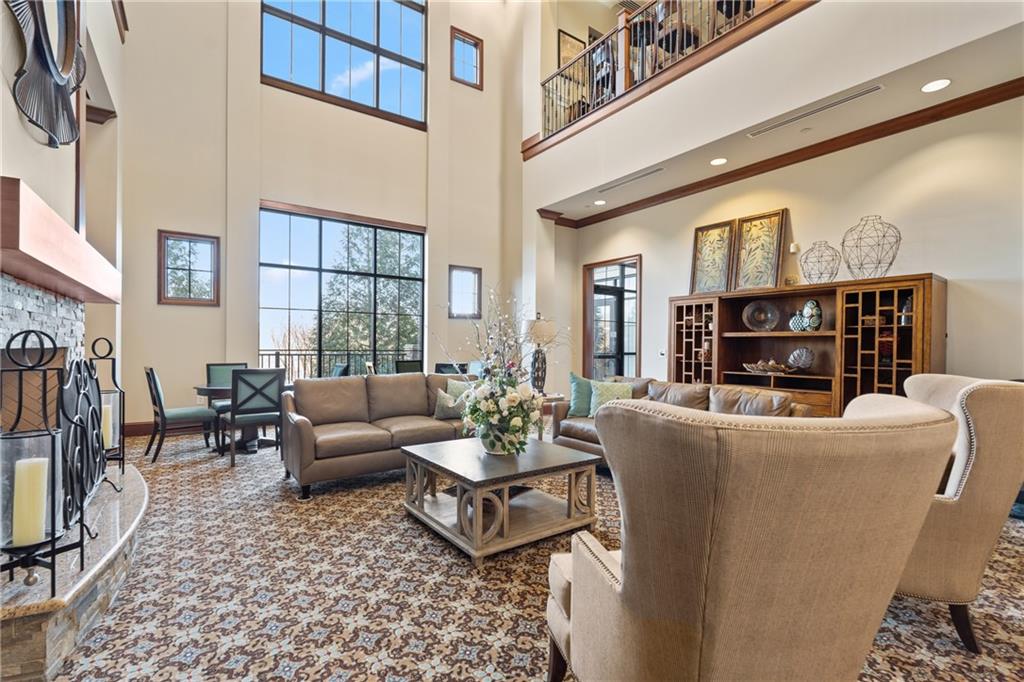 3457 Locust Cove Road Gainesville, GA 30504 - Photo 45 of 54 a living room with furniture a fireplace and large windows