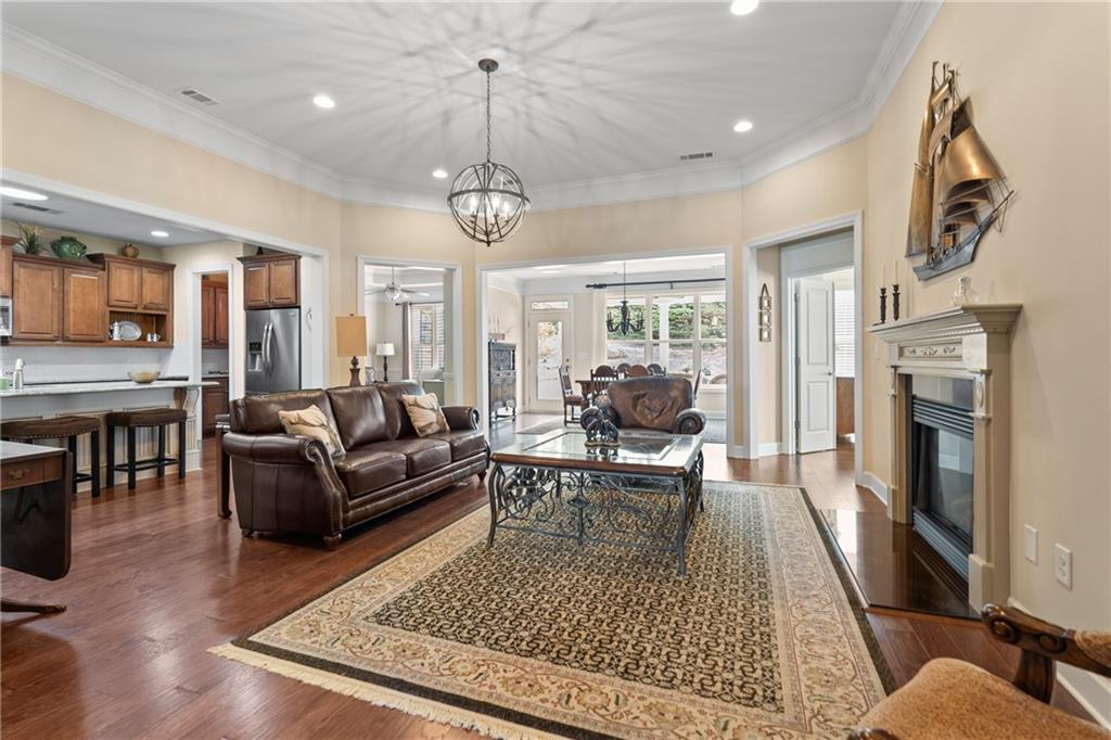 3457 Locust Cove Road Gainesville, GA 30504 - Photo 9 of 54 a living room with furniture a fireplace and a chandelier