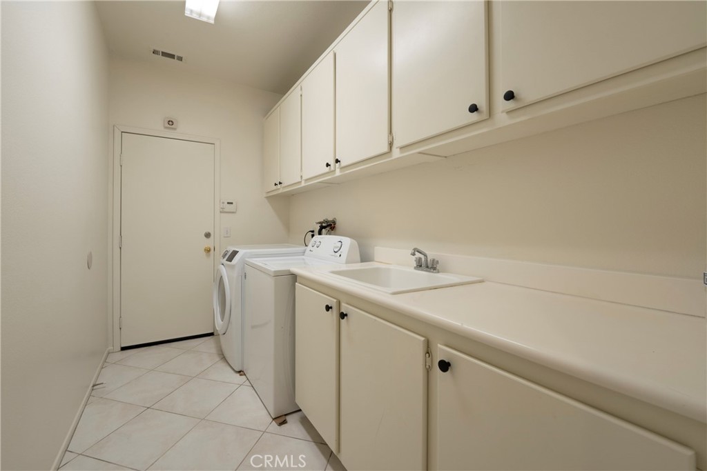 6319 Lavender Street Eastvale, CA 92880 - Photo 13 of 39 a utility room with a sink washer and dryer
