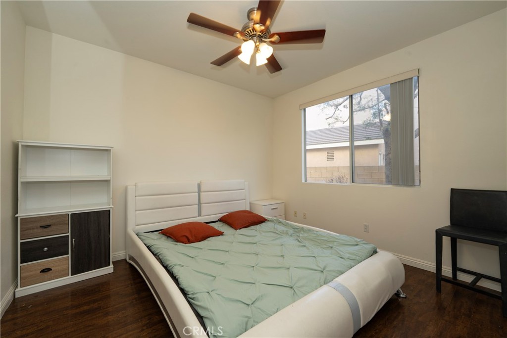 6319 Lavender Street Eastvale, CA 92880 - Photo 14 of 39 a bedroom with a bed and a chandelier