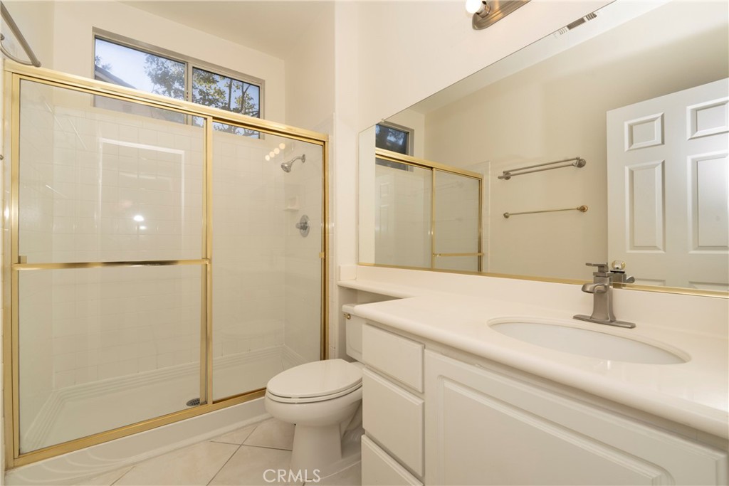 6319 Lavender Street Eastvale, CA 92880 - Photo 15 of 39 a bathroom with a granite countertop shower sink vanity and toilet