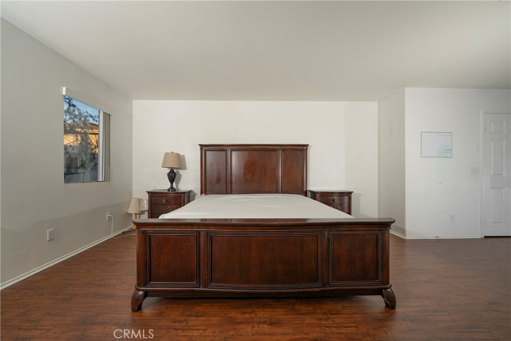 6319 Lavender Street Eastvale, CA 92880 - Photo 21 of 39 a bedroom with a bed and a night stand