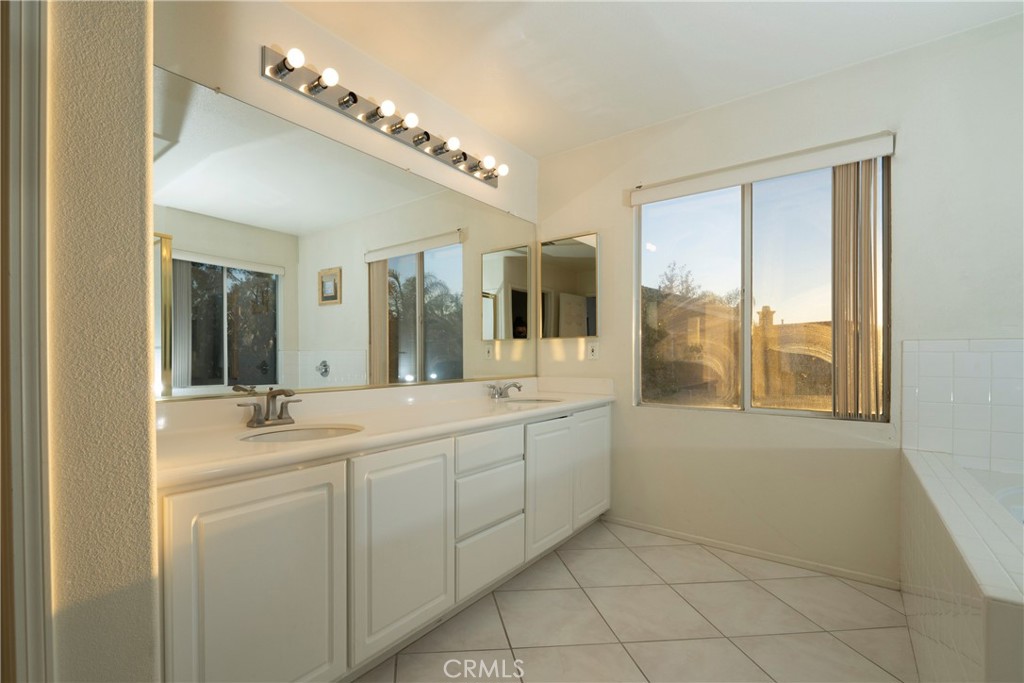 6319 Lavender Street Eastvale, CA 92880 - Photo 24 of 39 a bathroom with a double vanity sink and a mirror