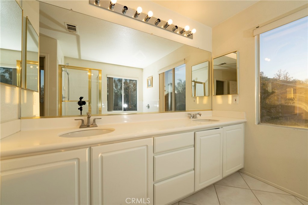 6319 Lavender Street Eastvale, CA 92880 - Photo 25 of 39 a bathroom with a sink and a mirror