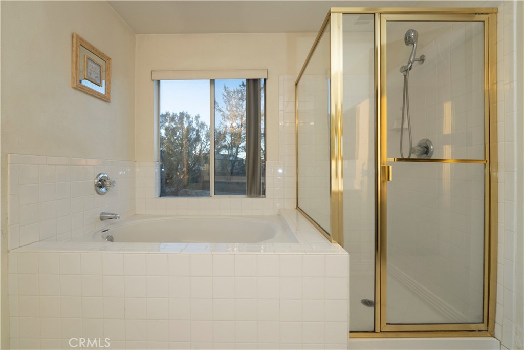 6319 Lavender Street Eastvale, CA 92880 - Photo 26 of 39 a bathroom with a bathtub and a shower