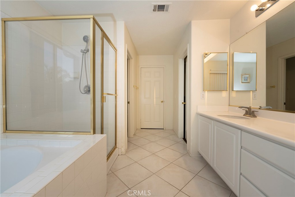 6319 Lavender Street Eastvale, CA 92880 - Photo 27 of 39 a spacious bathroom with a shower and a sink