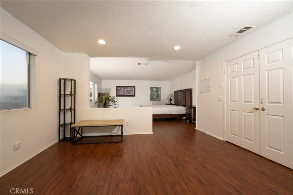 6319 Lavender Street Eastvale, CA 92880 - Photo 28 of 39 a living room with furniture and a wooden floor