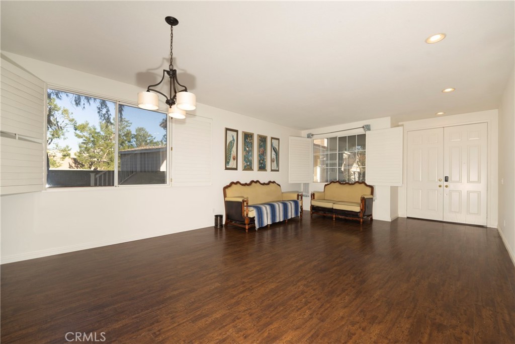 6319 Lavender Street Eastvale, CA 92880 - Photo 3 of 39 a living room with furniture and a chandelier