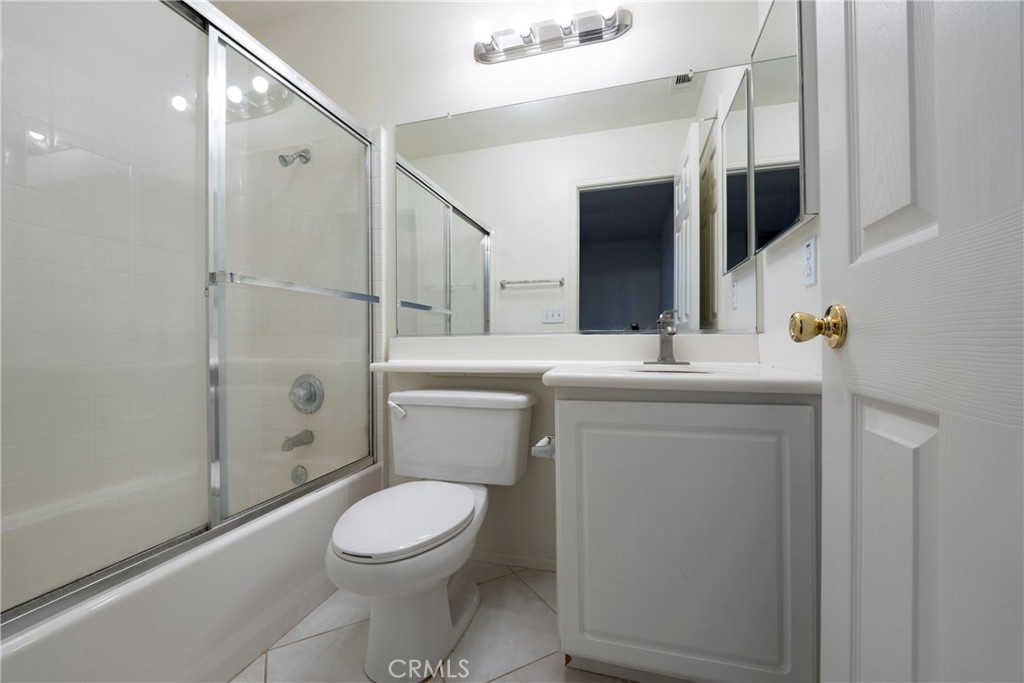 6319 Lavender Street Eastvale, CA 92880 - Photo 32 of 39 a bathroom with a toilet a sink and shower