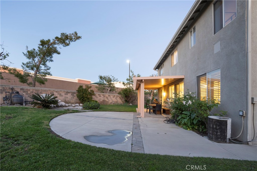 6319 Lavender Street Eastvale, CA 92880 - Photo 38 of 39 a view of a house with a yard and potted plants
