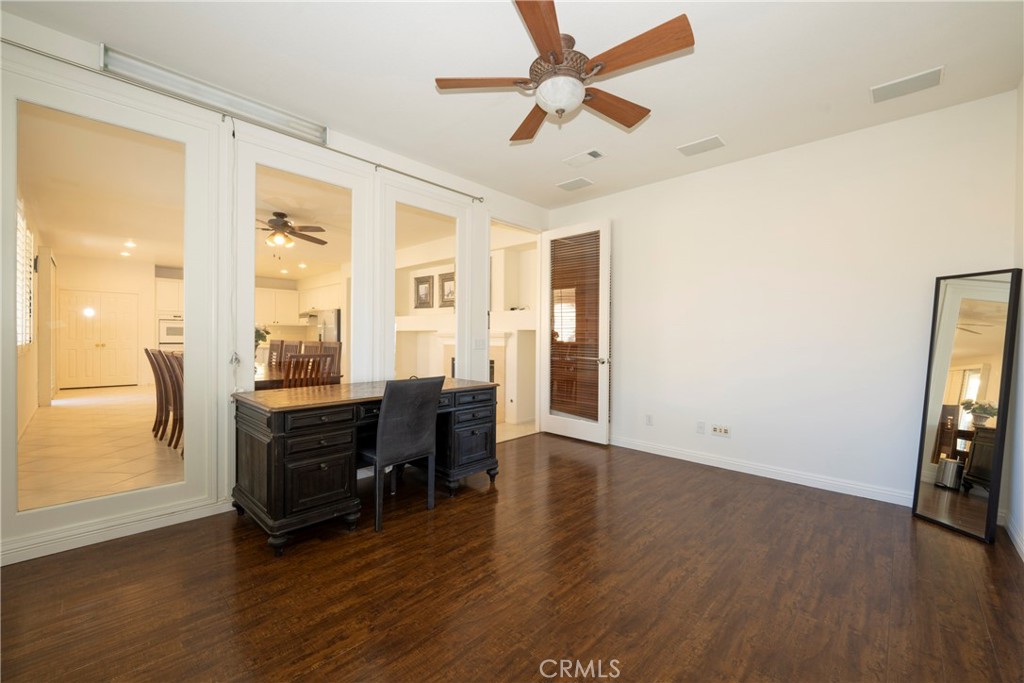 6319 Lavender Street Eastvale, CA 92880 - Photo 5 of 39 a view of workspace with wooden floor and ceiling fan