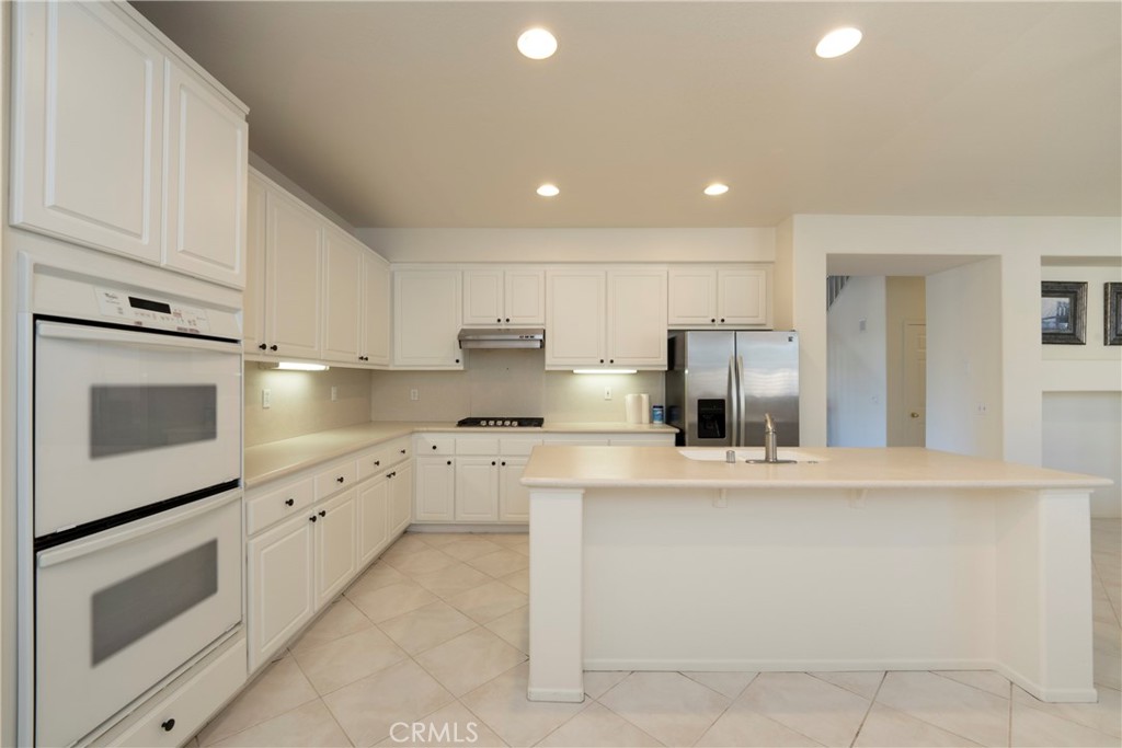 6319 Lavender Street Eastvale, CA 92880 - Photo 7 of 39 a kitchen with cabinets and stainless steel appliances