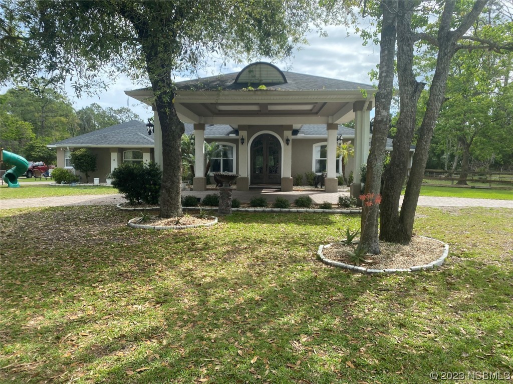 32 Winchester Road Ormond Beach, FL 32174 - Photo 1 of 84 a front view of a house with garden