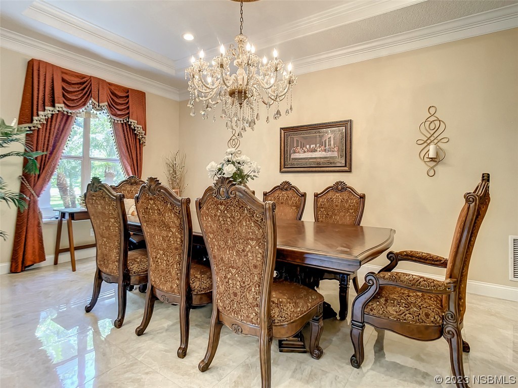 32 Winchester Road Ormond Beach, FL 32174 - Photo 12 of 84 a view of a dining room with furniture and a chandelier