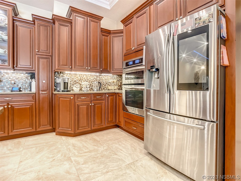 32 Winchester Road Ormond Beach, FL 32174 - Photo 17 of 84 a kitchen with stainless steel appliances granite countertop a refrigerator and a sink