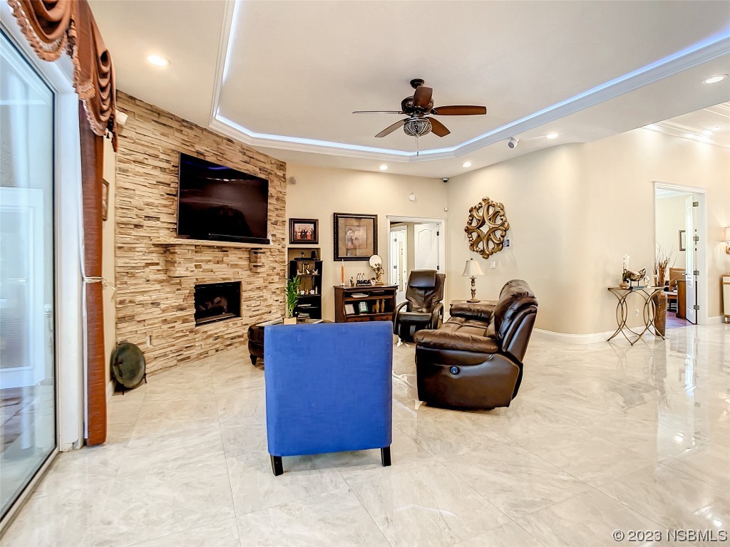 32 Winchester Road Ormond Beach, FL 32174 - Photo 22 of 84 a living room with furniture a flat screen tv and a fireplace