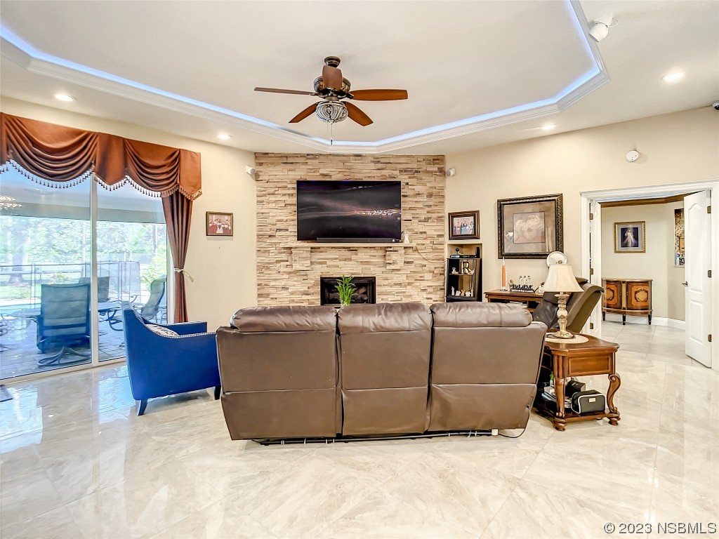 32 Winchester Road Ormond Beach, FL 32174 - Photo 23 of 84 a living room with furniture a flat screen tv and a window