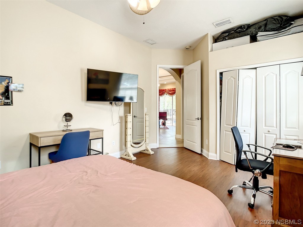 32 Winchester Road Ormond Beach, FL 32174 - Photo 36 of 84 a bedroom with a bed and a flat screen tv