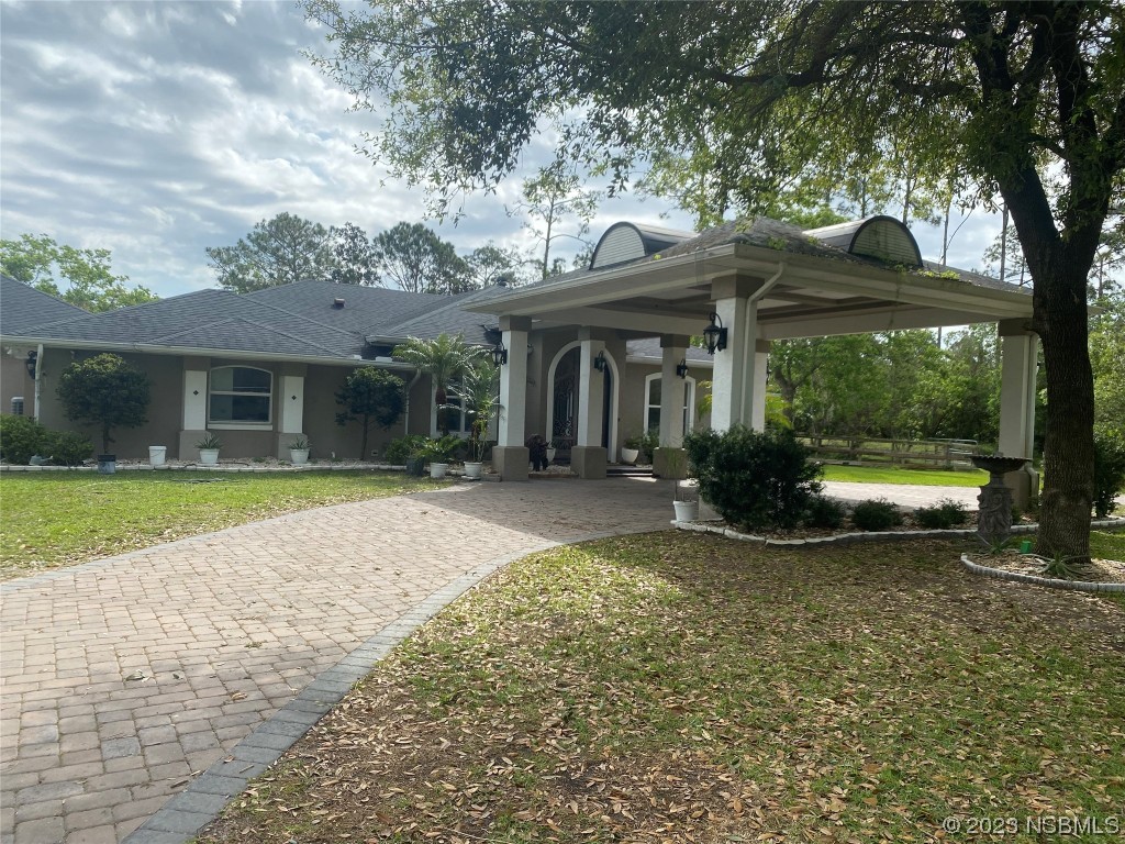 32 Winchester Road Ormond Beach, FL 32174 - Photo 5 of 84 a view of a house with a yard and large tree