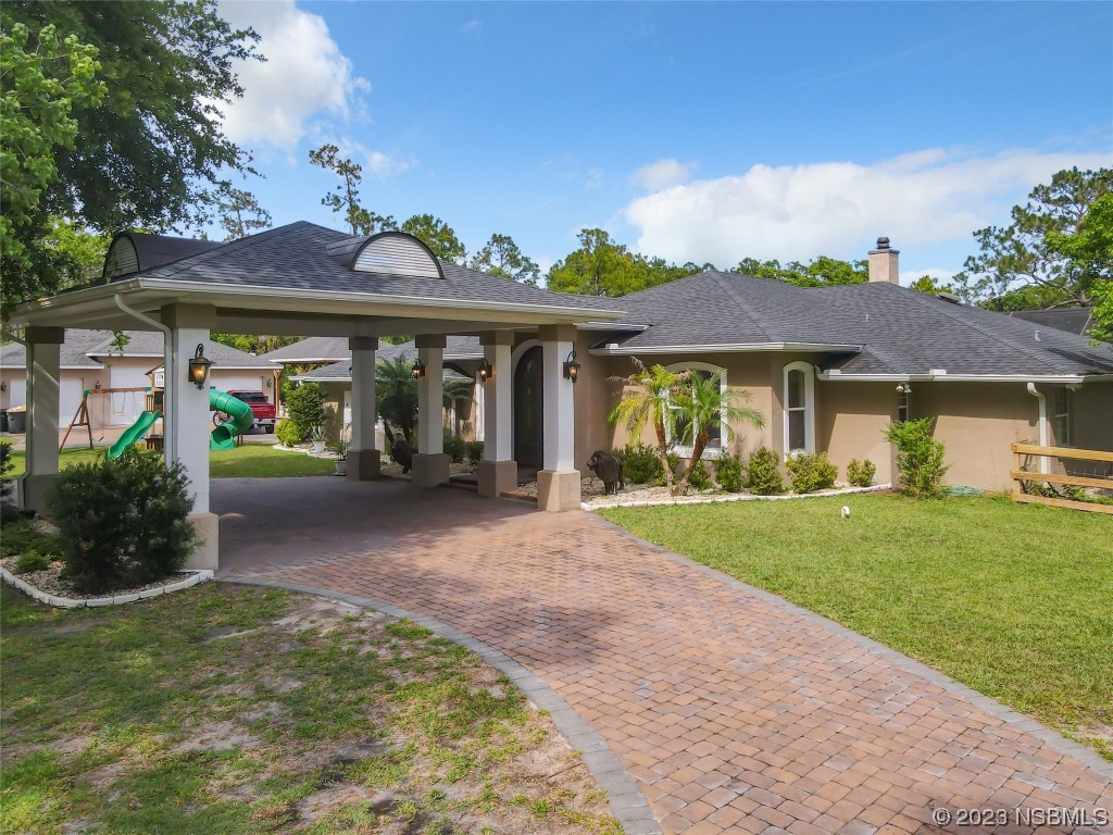 32 Winchester Road Ormond Beach, FL 32174 - Photo 53 of 84 a front view of a house with garden