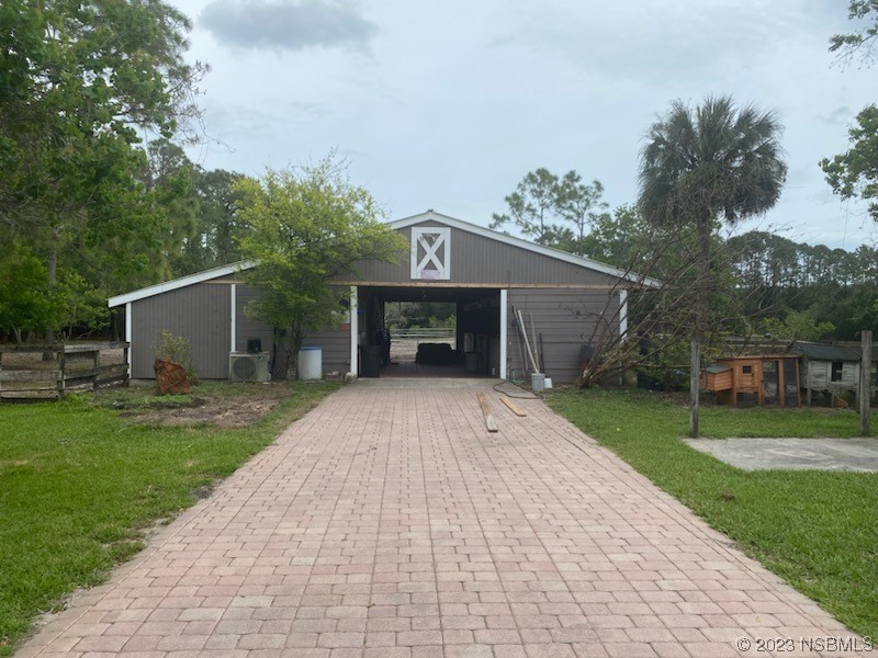32 Winchester Road Ormond Beach, FL 32174 - Photo 7 of 84 a front view of a house with a yard and garage