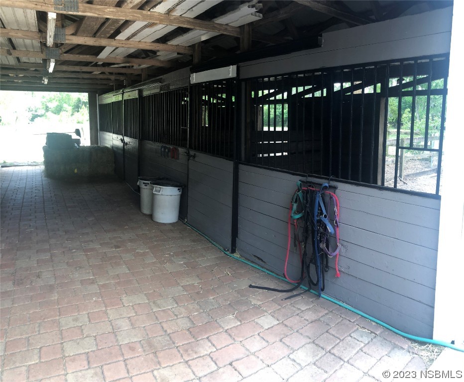 32 Winchester Road Ormond Beach, FL 32174 - Photo 8 of 84 a view of a porch with a table and chairs